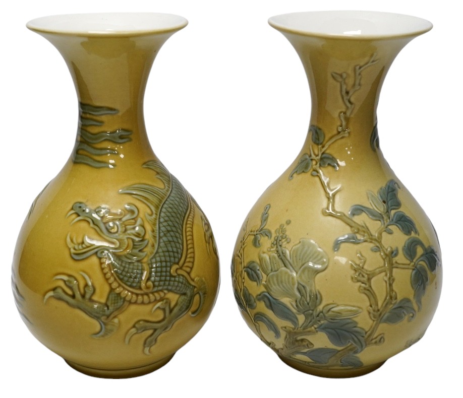 Two Lladro vases decorated in relief with dragons and birds, 26cm high. Condition - good